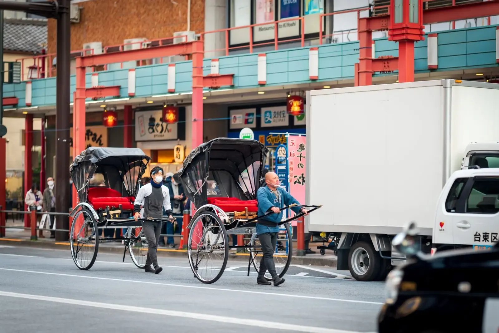 Traditional rickshaw drivers on a street in Asakusa, Tokyo