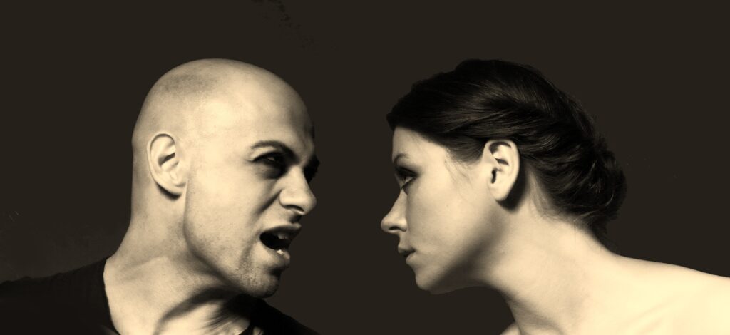 Three people in tense conversation illustrating conflict and power dynamics in relationships